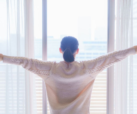 A person greeting the early morning sun as part of a healthy daily routine.