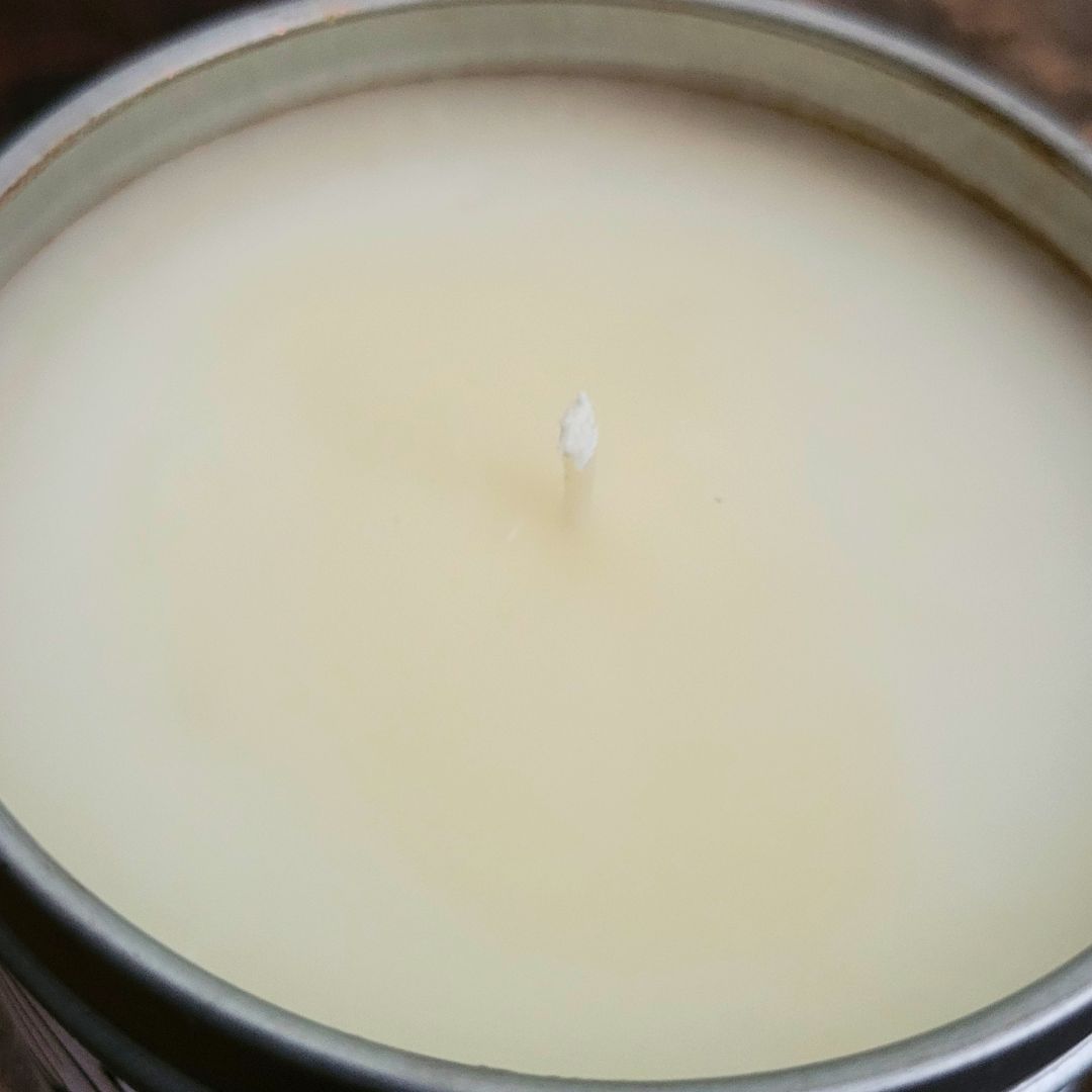 Close-up of a candle with a wick in a metal container